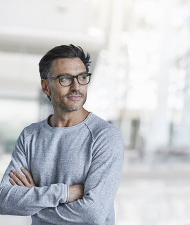 Portrait of content mature man with stubble wearing glasses - PNEF00552