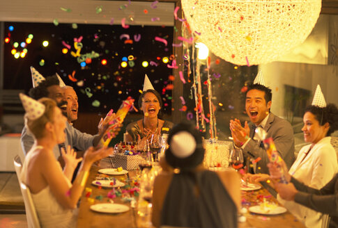 Friends throwing confetti at birthday party - CAIF04857