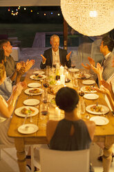 Friends applauding man at dinner party - CAIF04868
