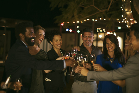 Freunde stoßen auf einer Party aufeinander an, lizenzfreies Stockfoto