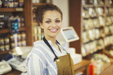 Portrait smiling, confident female worker in grocery store - CAIF05261