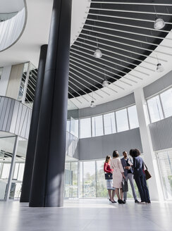 Geschäftsleute im Gespräch im modernen Büro-Atrium - CAIF05493