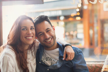 Portrait happy young couple hugging in cafe - CAIF05641