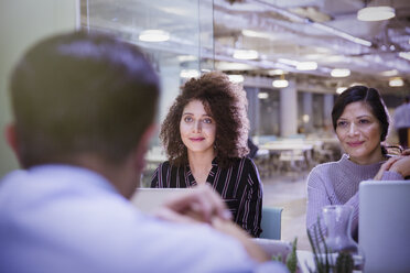 Businesswomen listening in conference room meeting - CAIF05688