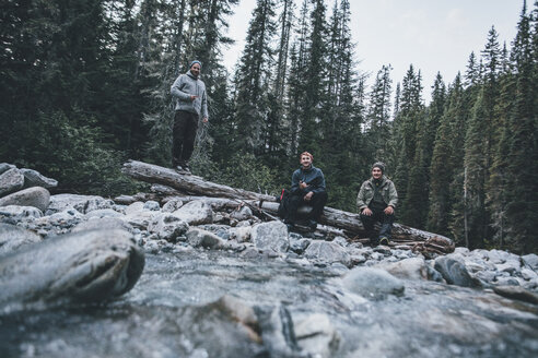 Kanada, British Columbia, Glacier National Park, drei Freunde am Illecillewaet River im Wald - GUSF00431