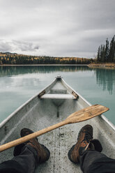 Canada, British Columbia, legs of a man in canoe on Boya Lake - GUSF00497