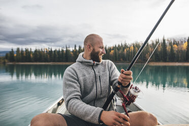 Canada, British Columbia, man fishing in canoe on Boya Lake - GUSF00501