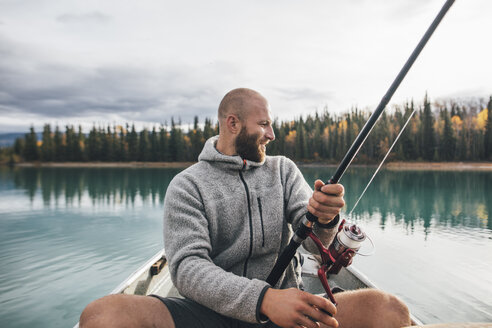 Canada, British Columbia, man fishing in canoe on Boya Lake - GUSF00501