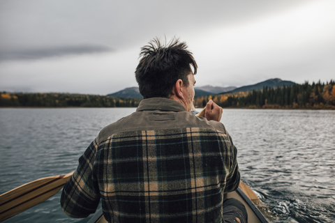 Canada, British Columbia, man in canoe on Boya Lake stock photo