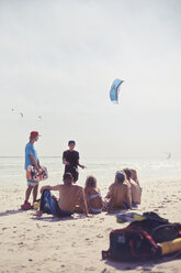 Freunde lernen Kiteboarding am sonnigen Strand - CAIF05906