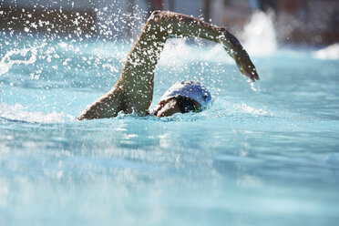 Male swimmer athlete swimming in swimming pool - CAIF05995