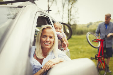 Portrait smiling mother and daughter in car - CAIF06068