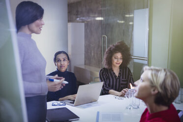 Businesswomen planning, talking in conference room meeting - CAIF06142