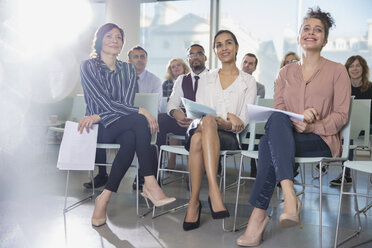 Attentive businesswomen listening in conference audience - CAIF06183