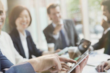 Businessman touching digital tablet in conference room meeting - CAIF06217