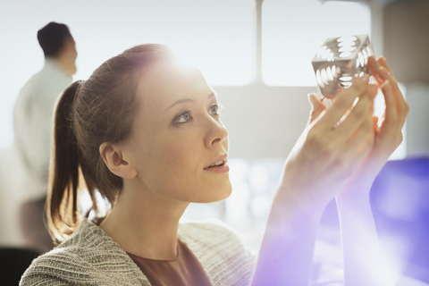 Focused design professional examining prototype part in office stock photo