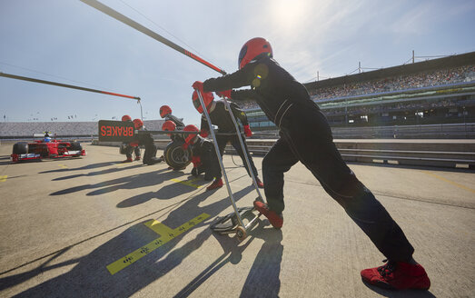 Boxencrew bereitet sich auf den Boxenstopp eines Formel-1-Rennwagens in der Boxengasse vor - CAIF06424