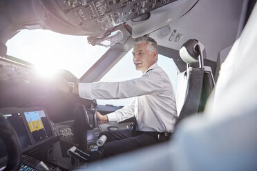 Smiling male pilot in airplane cockpit - CAIF06586