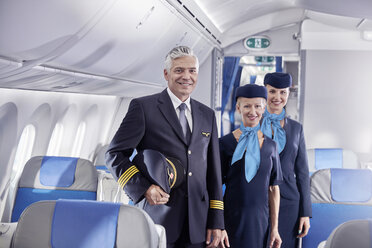 Portrait confident pilot and flight attendants on airplane - CAIF06589