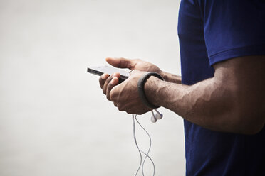 Midsection of man using mobile phone - CAVF01105