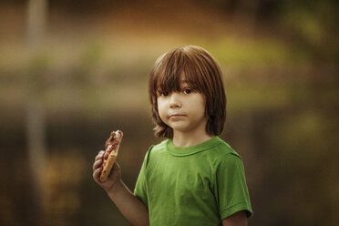 Portrait of boy holding pizza slice - CAVF01212