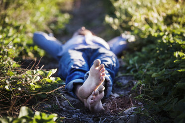 Man lying on field at farm - CAVF01294