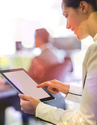 Businesswoman using digital tablet in office - CAIF06764