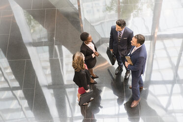 Corporate business people talking in modern office lobby - CAIF06822