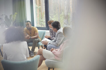 Menschen hören einem Mann in einer Gruppentherapiesitzung zu - CAIF06852