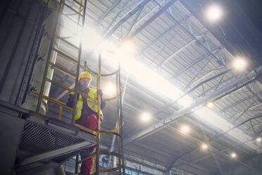 Steelworker on platform in steel mill - CAIF06909