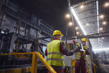 Steelworkers moving steel part in steel mill - CAIF06967