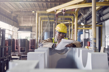 Steelworker with clipboard in steel mill - CAIF06977