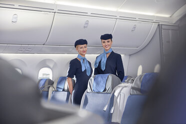 Portrait smiling, confident female flight attendants on airplane - CAIF07010