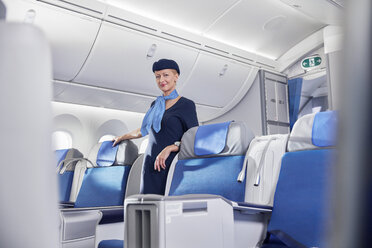 Portrait confident female flight attendant on airplane - CAIF07020