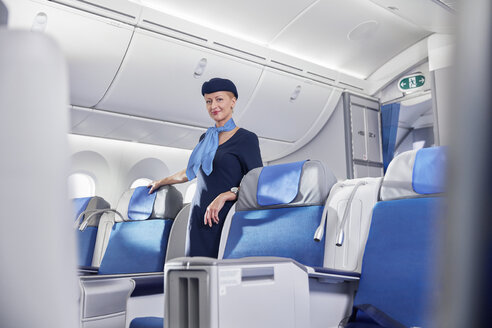Porträt selbstbewusste weibliche Flugbegleiterin im Flugzeug - CAIF07020