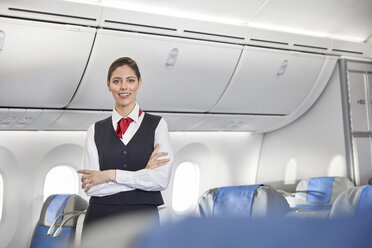 Portrait smiling, confident female flight attendant on airplane - CAIF07022