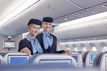 Portrait smiling, confident female flight attendants on airplane - CAIF07026