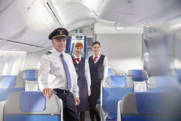 Portrait confident pilot and flight attendants on airplane - CAIF07029
