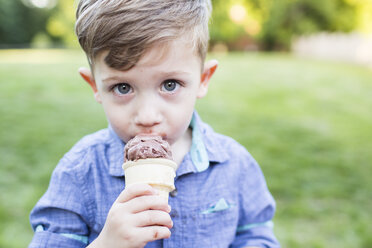 Portrait cute preschool boy eating ice cream cone - CAIF07236