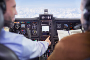 Pilots flying airplane in cockpit - CAIF07465