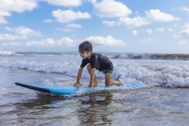 Indonesia, Bali, boy on surfboard - KNTF01096