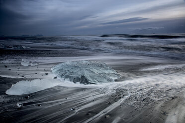 Ice on stormy cold ocean beach, Jokulsarlon, Iceland - CAIF07526