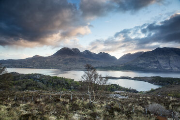 Scenic view clouds over calm mountains and lake, Russel Burn, Applecross, Scotland - CAIF07540
