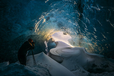 Photographer in ice cave, Iceland - CAIF07627