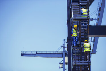 Workers climbing cargo crane - CAIF07651