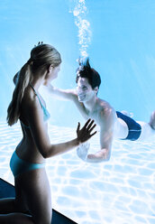 Woman at window smiling at man underwater - CAIF07769