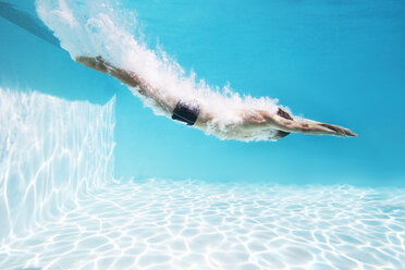 Man diving into swimming pool - CAIF07770