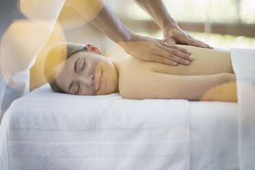 Woman receiving massage at spa - CAIF07778
