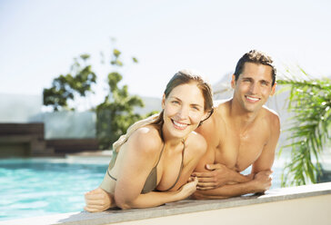 Couple relaxing in swimming pool - CAIF07794