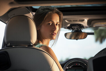 Portrait of woman sitting in car - CAVF01384